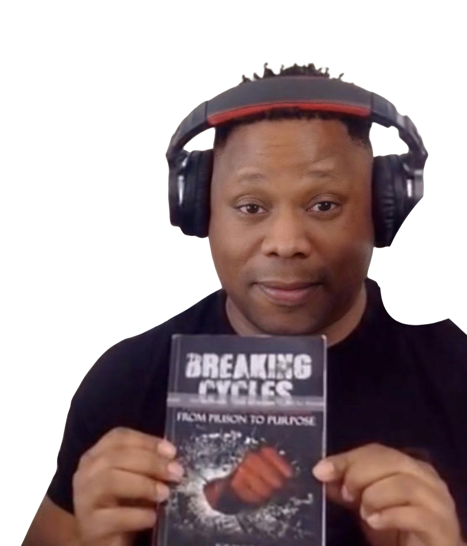 Agos Youngsam holding his book Breaking Cycles: From Prison to Purpose
